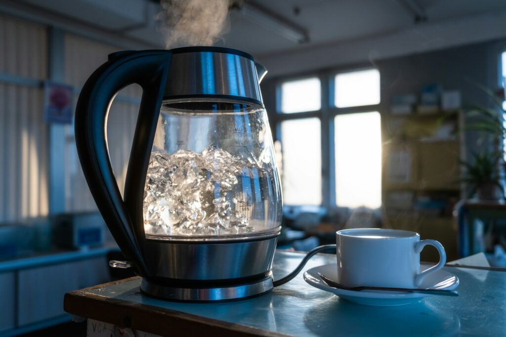 Transparent kettle with water boils